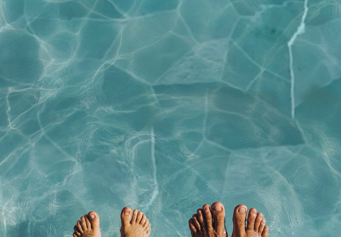 barn- och vuxenfötter i varm pool